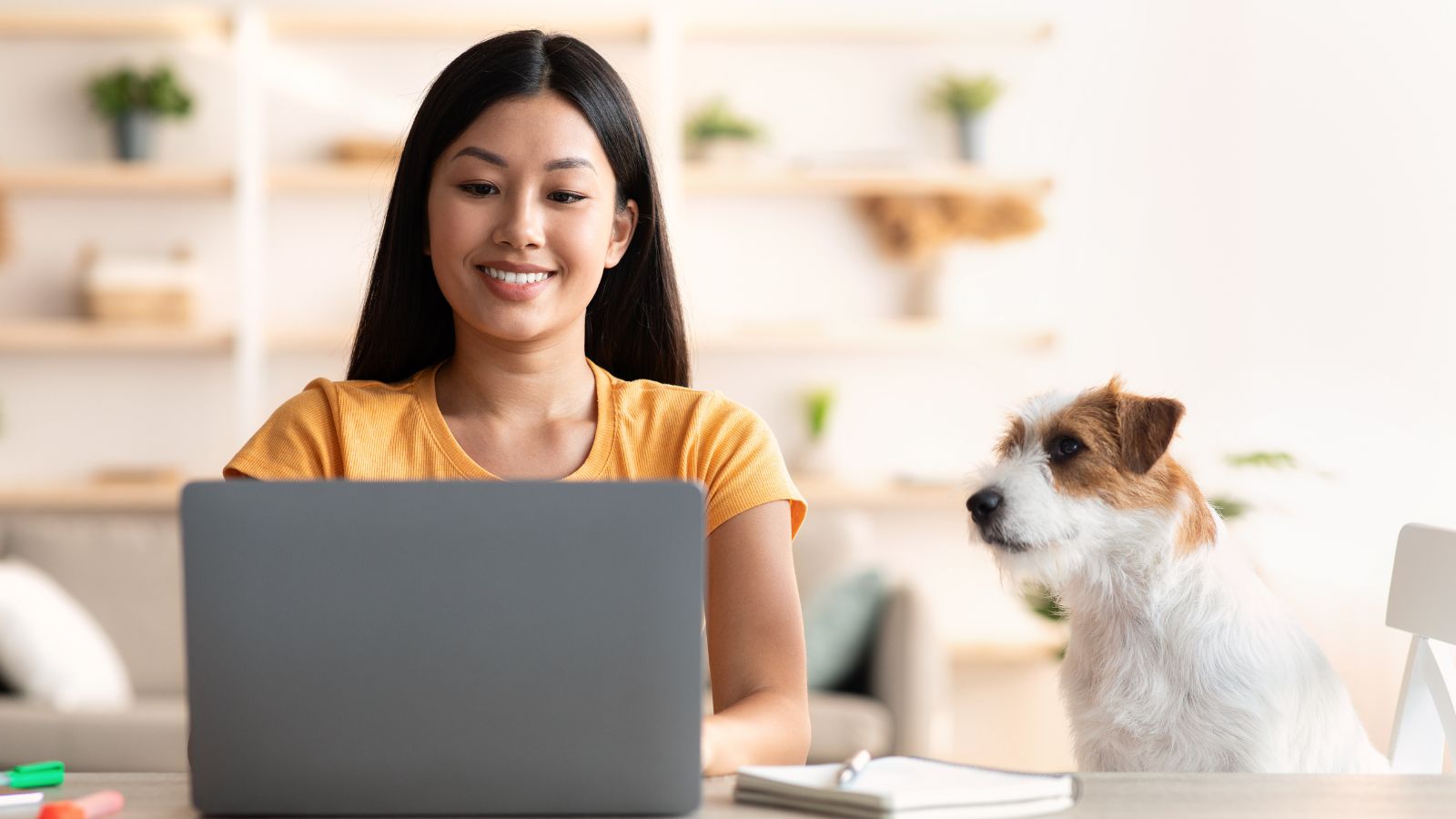 woman with dog working from home